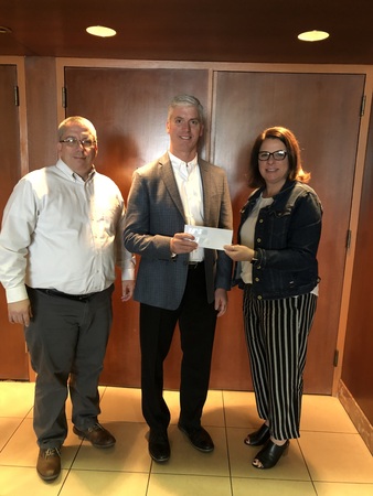 MCAO President Tim Farber thanks representatives from the MCA of Northwest Ohio John White and Anne Saloff for their generous PAC contribution.
